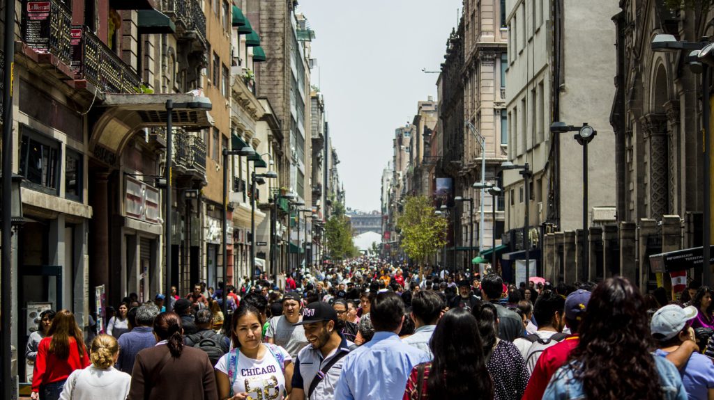 crowd of people walking on a street in Mexico City